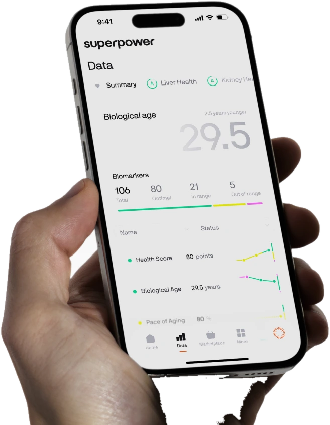 The Superpower member app held in a hand, showing biological age and biomarkers